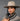 Ruana carranguera cuello tejido gris, detalle del cuello tejido a mano, mujer con sombrero de ala ancha en estudio.