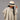 Ruana carranguerita infantil gris claro, niña con sombrero, vista frontal en estudio.
