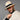 Ruana doble faz gruesa reversible mostrando el lado marfil, hombre con sombrero en estudio.
